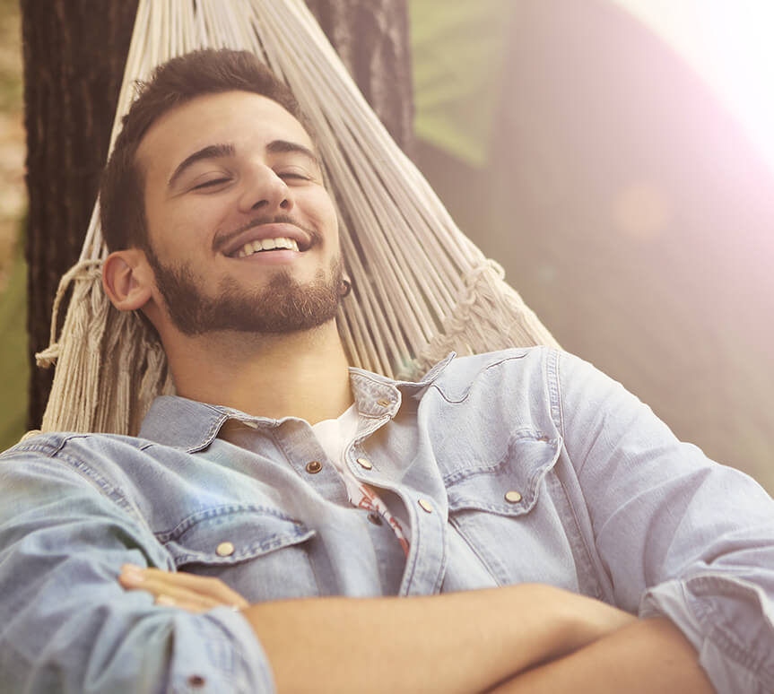 man relaxing in a hammock