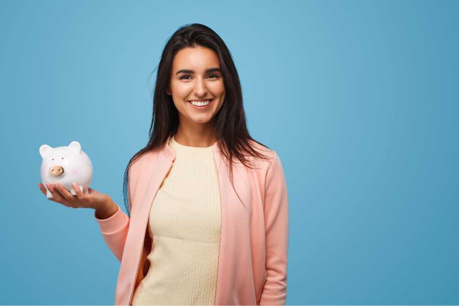 smiling woman holding a piggy bank