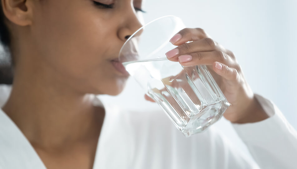 woman drinking a glass of water