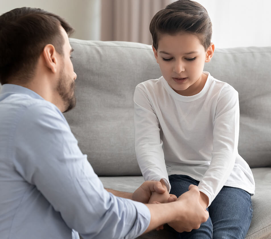 father talking with his anxious young son