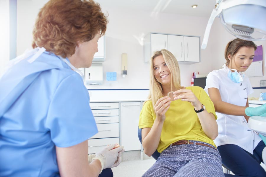 young woman talks about orthodontic options with the dental staff