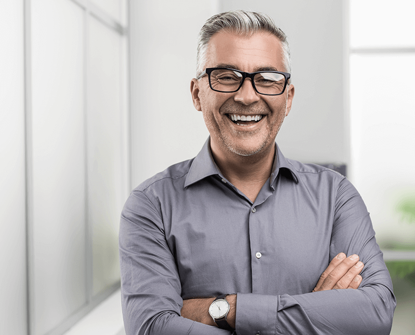 man with crossed arms smiling