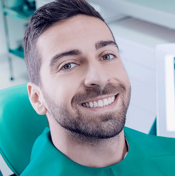 man smiling at the dentist