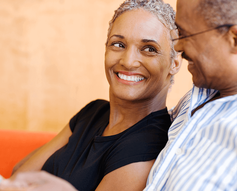 senior couple smiling at each other