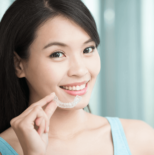 smiling woman with aligner