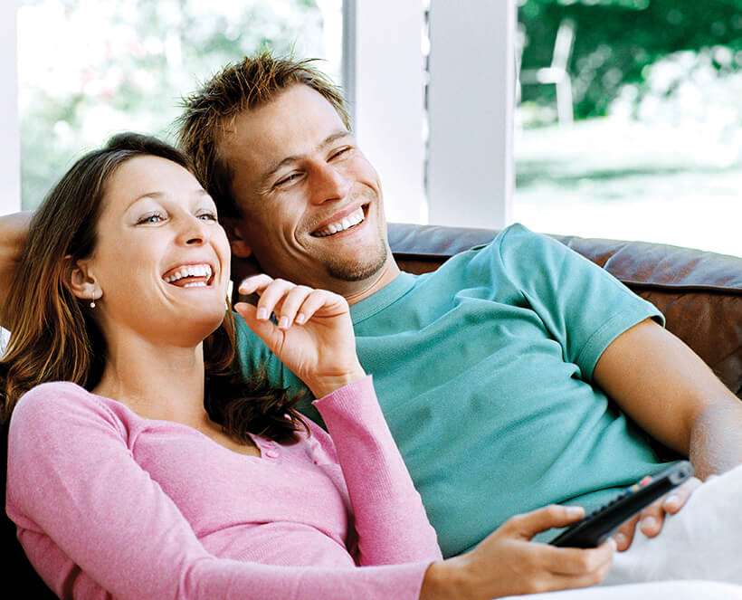 happy couple watching tv