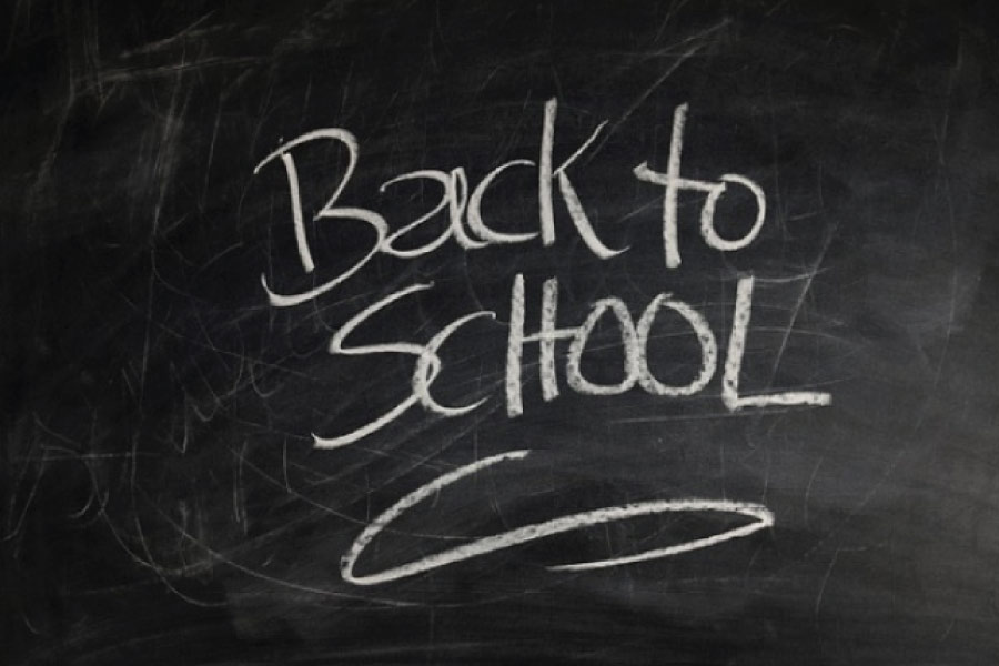 back to school written on a blackboard in chalk