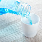 mouthwash being poured into a cup