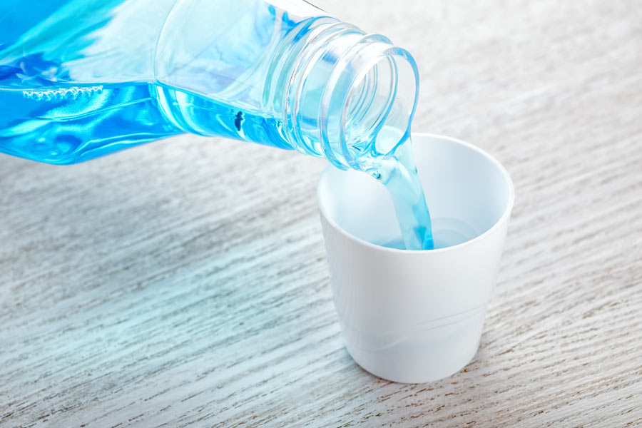 mouthwash being poured into a cup