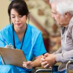 senior man discusses restorative dentistry with female dental technician