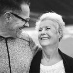 senior couple walk close together and smile after learning about diabetes and oral health