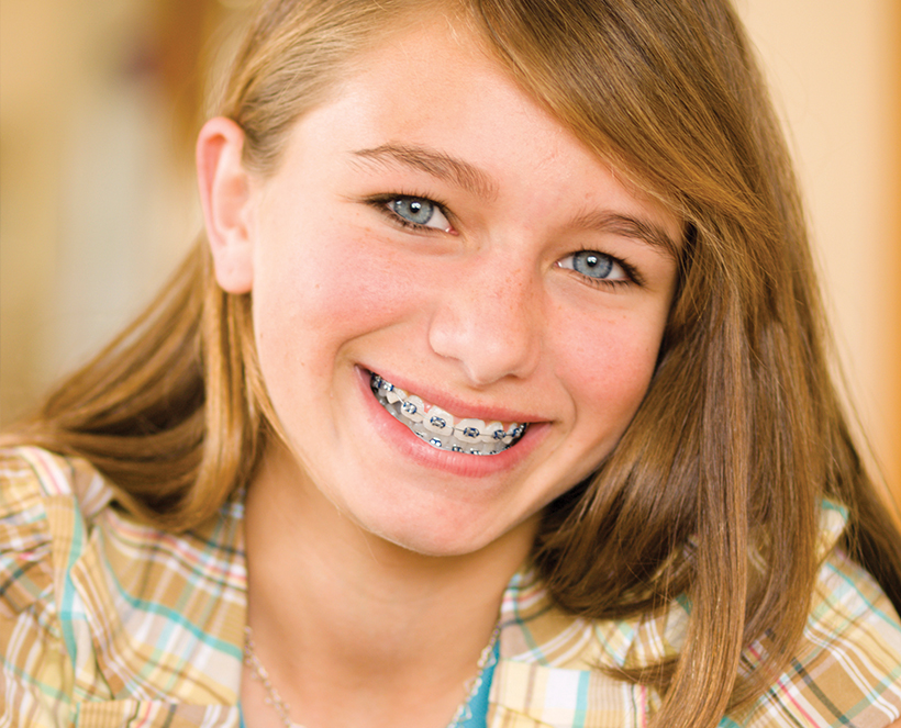 smiling young girl with braces