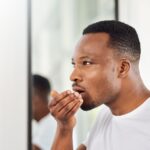man checking for bad breath or halitosis