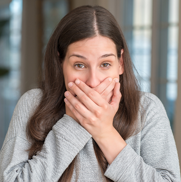 woman covering her mouth
