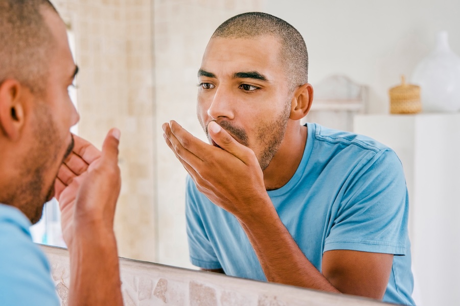 man checking for bad breath looking for halitosis treatment
